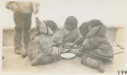 Image of Eskimo [Inuit] children eating on deck of Bowdoin